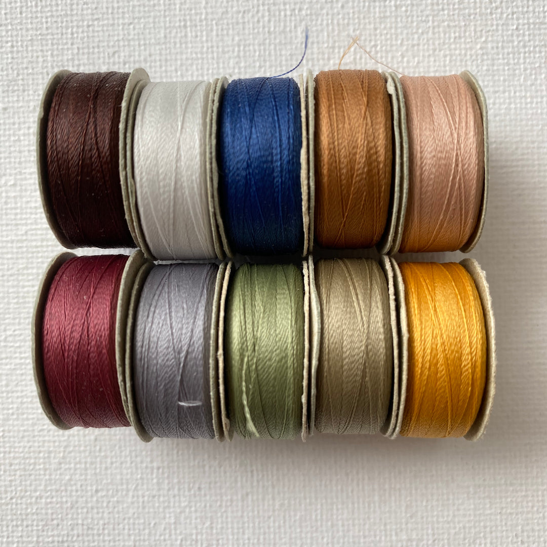 10 assorted colors of the Bottom Line M-style bobbins